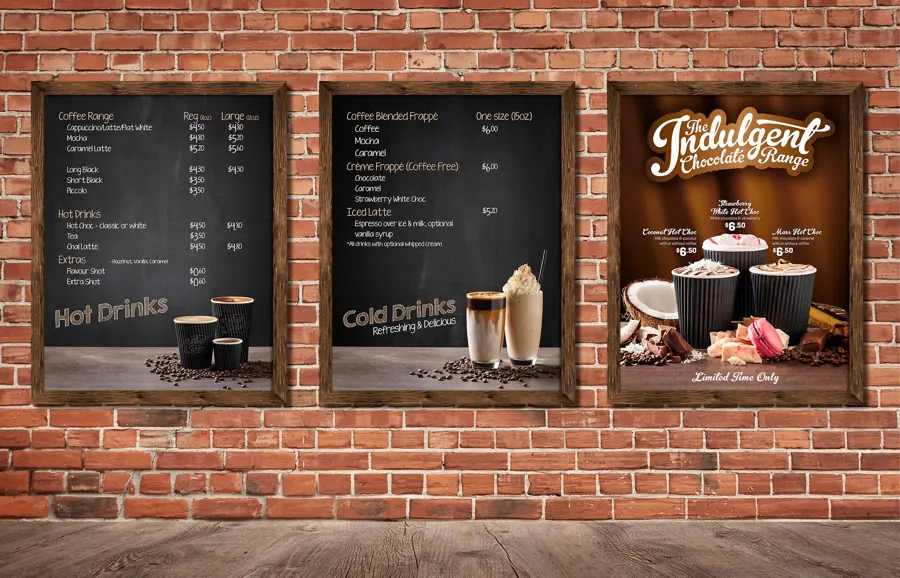 Chalkboard style coffee menus mounted on a red brick wall