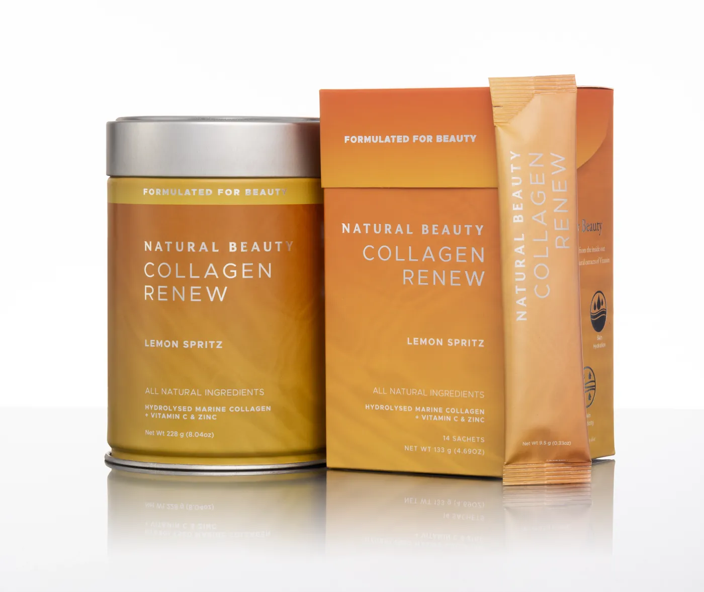 Natural Beauty Collagen Renew: the orange tin, sachet box and single sachet on a white studio surface