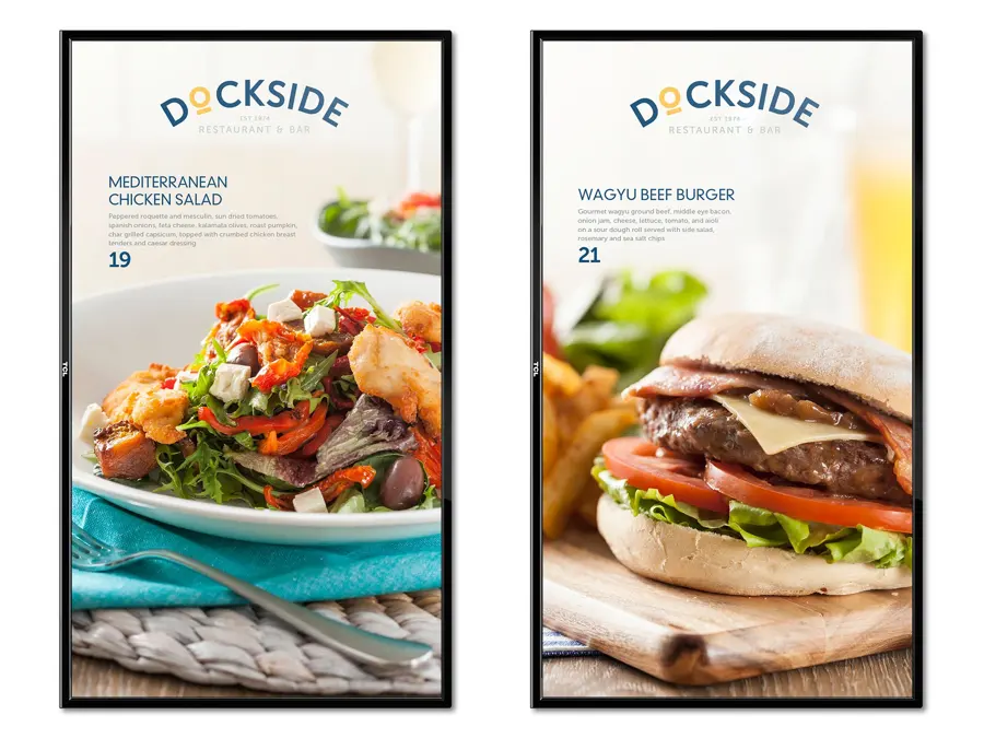 Two tall Dockside digital menu screens showing a salad and a burger