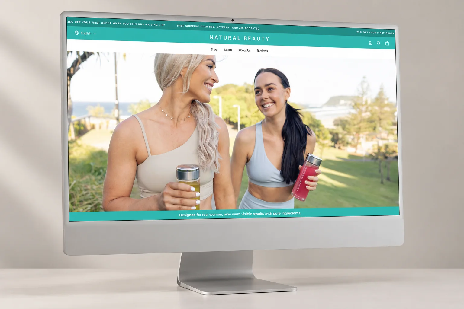 The Natural Beauty online store on a desktop screen: teal header and navigation over a photo of two women holding collagen drinks
