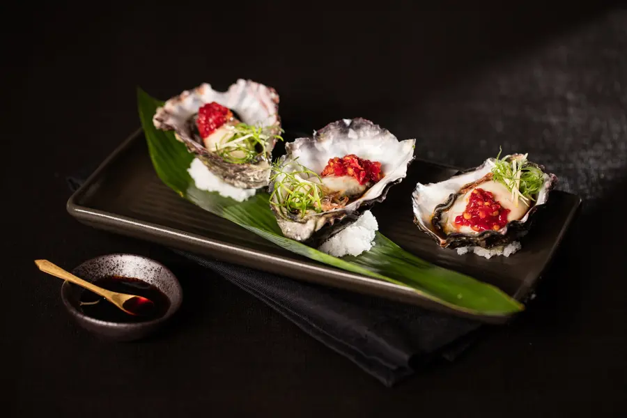 Dressed oysters on a banana leaf
