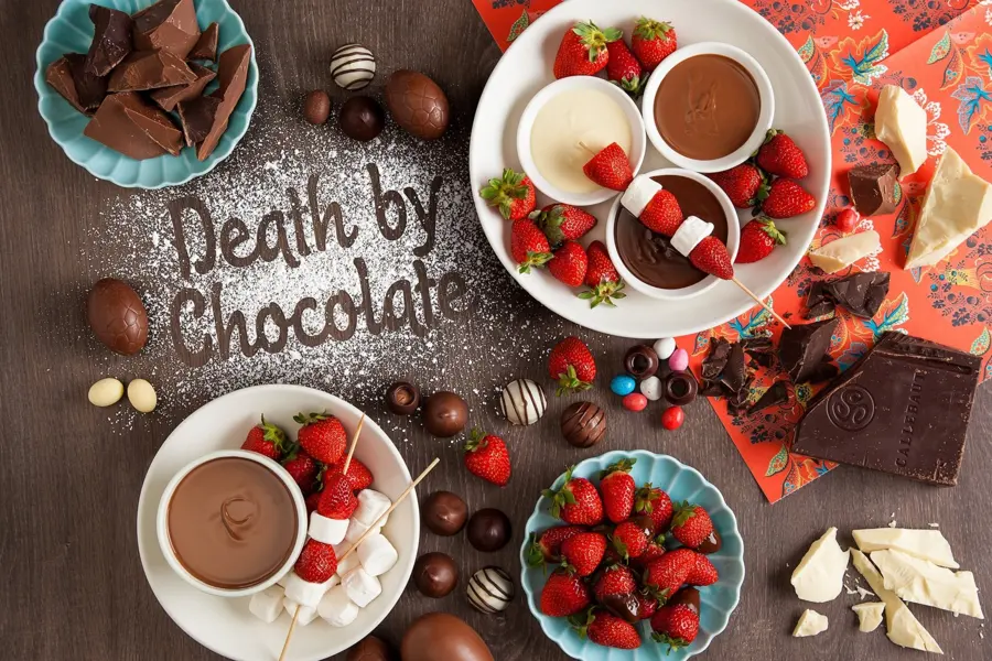Death by Chocolate dessert spread lettered in icing sugar