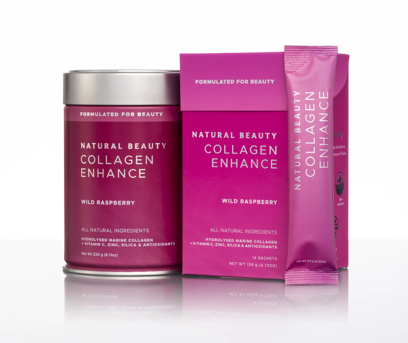 Natural Beauty Collagen Enhance: the raspberry pink tin, sachet box and single sachet on a white studio surface